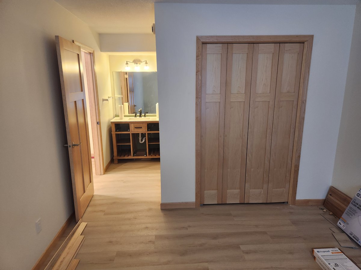 Bathroom and closet doors with trim installed by Home Visions Carpentry