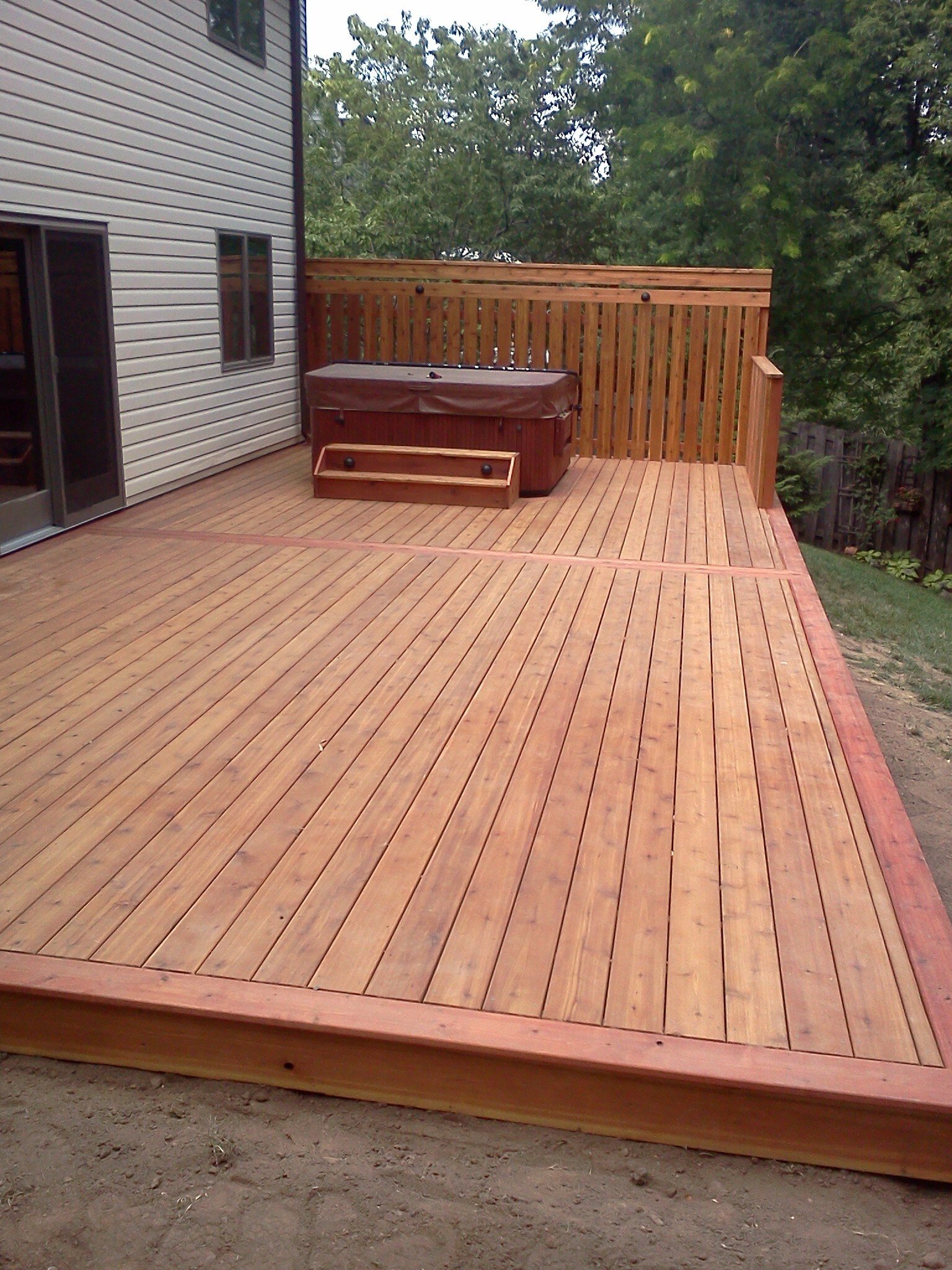 Deck with built-in hot tub platform designed by Minnesota carpenters at Home Visions Carpentry