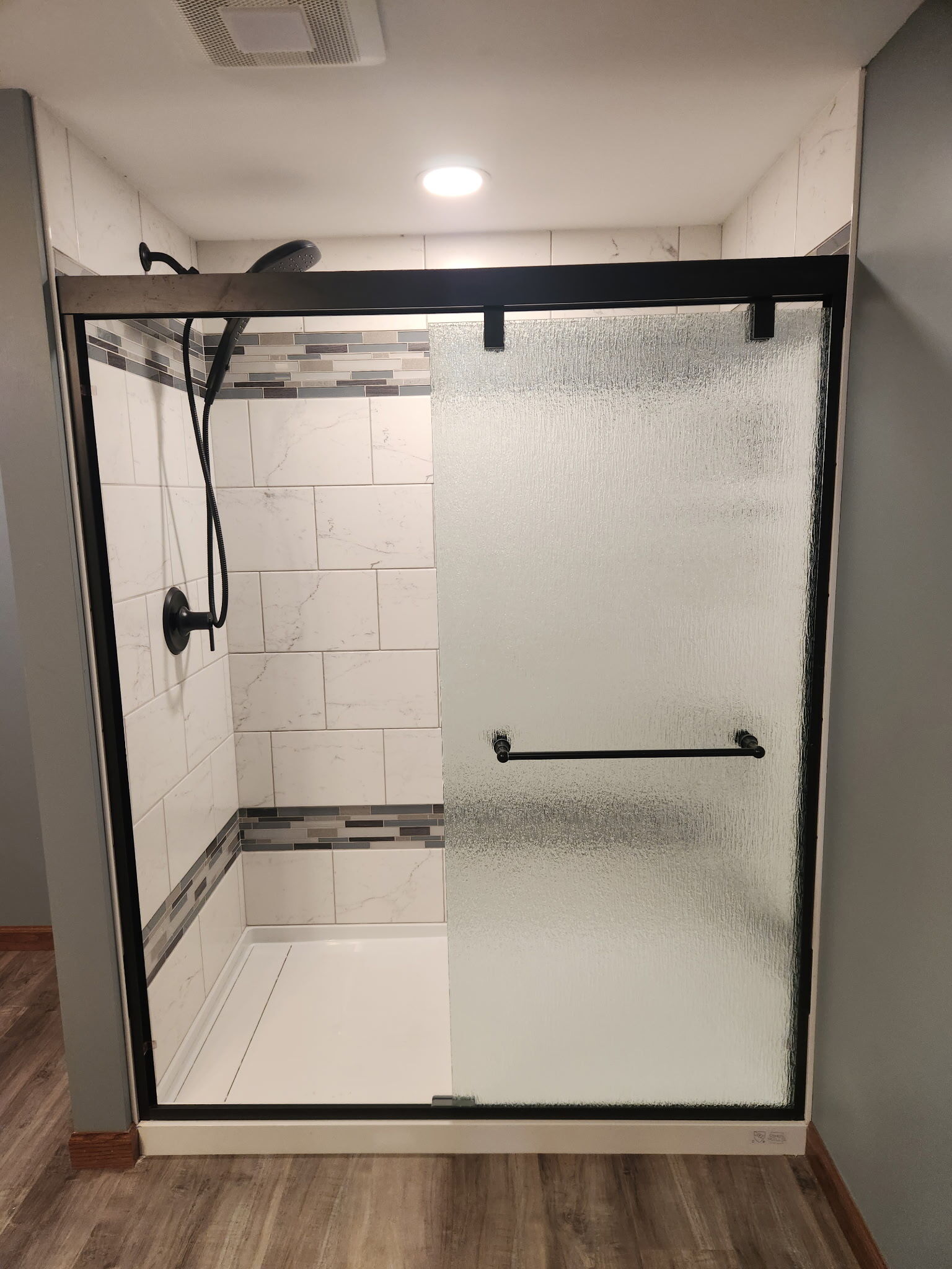 Beautifully finished shower and bathroom remodel by Home Visions Carpentry