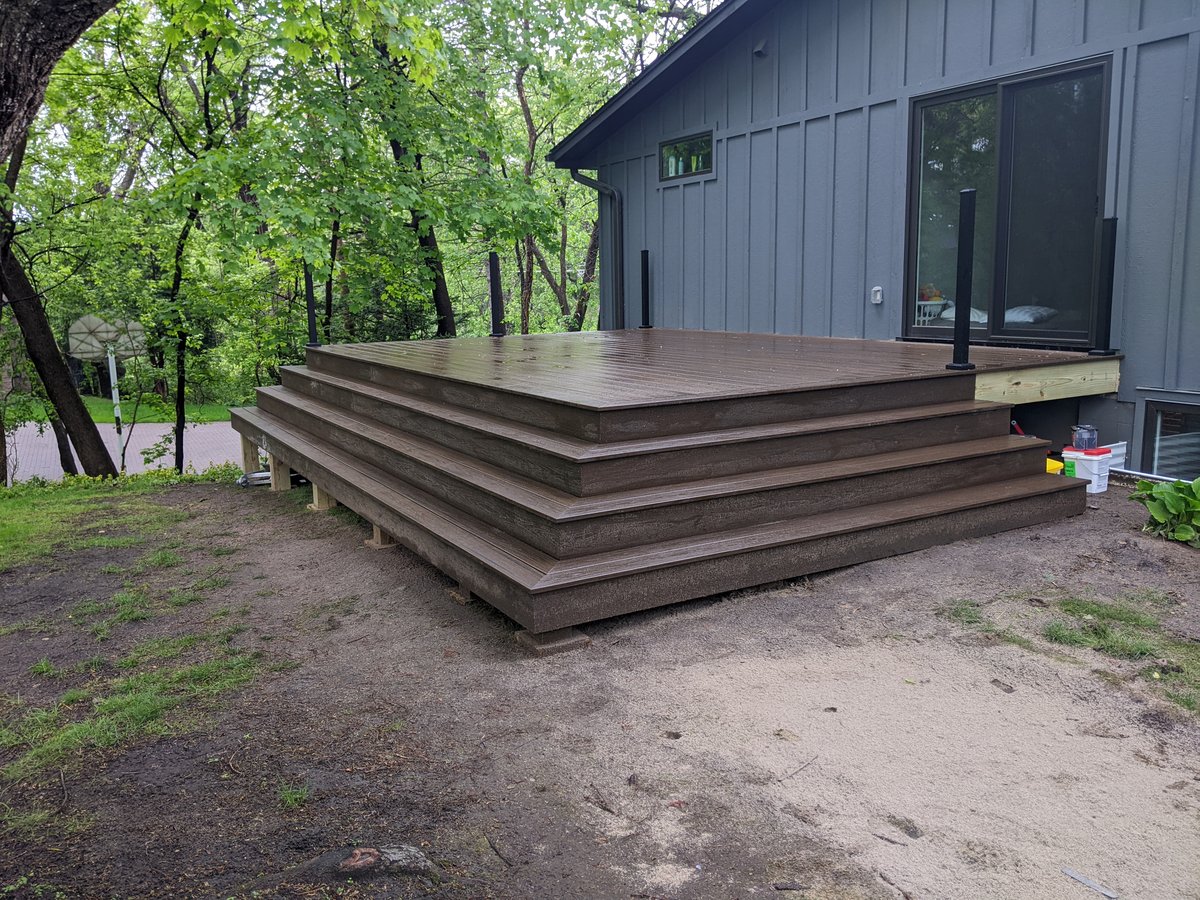 Deck with extended landing and wide stairway to backyard